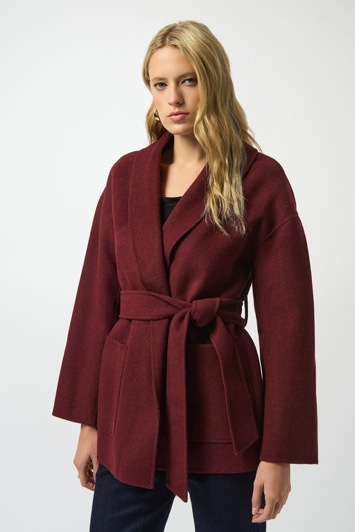 Woman wearing a burgundy wrap kimono coat with belt and front pockets
