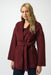 Woman wearing a burgundy wrap kimono coat with belt and front pockets