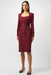 Woman wearing a burgundy knee length sheath dress with belt, square neck, and long sleeves