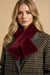 Woman wearing a red faux fur pull through scarf from Joseph Ribkoff