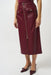 Woman wearing a burgundy leatherette midi skirt with zip front closure and front slit