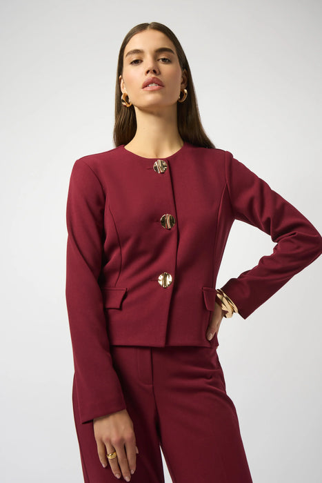 Woman wearing a red solid color blazer jacket with statement button front and long sleeves