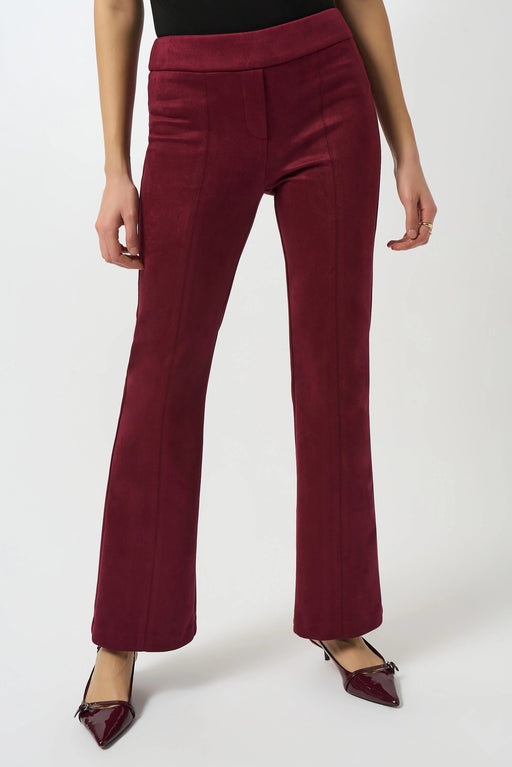 Woman wearing a red suede-like flared pant with pull on elastic waistband from Joseph Ribkoff