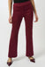 Woman wearing a red suede-like flared pant with pull on elastic waistband from Joseph Ribkoff