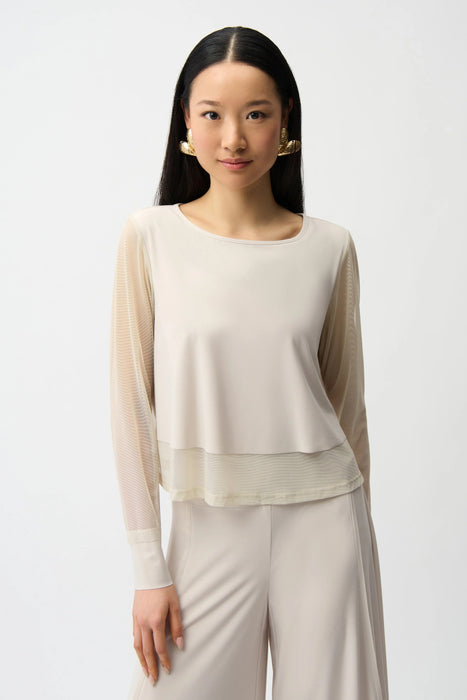 Woman wearing Joseph Ribkoff mesh sleeves layered lining top styled for evening events, office chic, dinner dates, and elegant modern occasions.