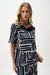 Woman wearing Joseph Ribkoff vanilla and midnight blue abstract print straight top styled for office wear, casual outings, and modern elegant everyday looks.