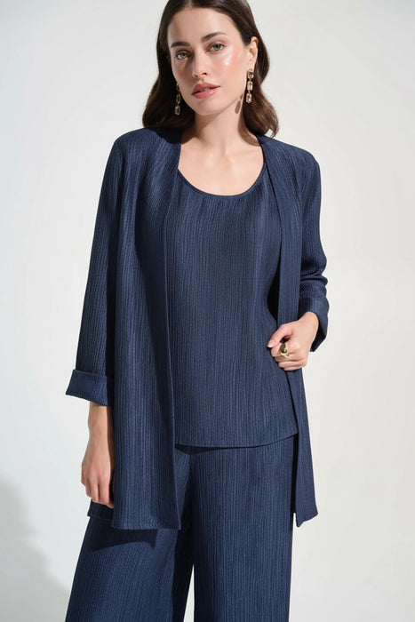 Woman wearing Joseph Ribkoff navy blue crinkle jacquard straight cover-up, featuring a textured fabric, open-front design, and elegant lightweight layering fit.