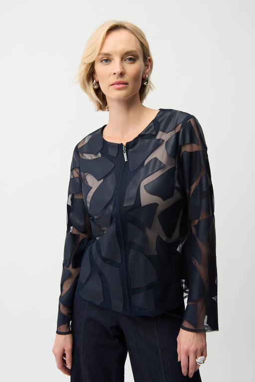 Woman wearing a dark blue zip-up mesh jacket with laser cutout leatherette details from Joseph Ribkoff