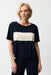 Woman wearing Joseph Ribkoff midnight blue color block boxy top styled for casual chic outings, office casual wear, travel days, and modern everyday fashion.