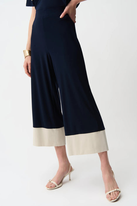 Woman wearing Joseph Ribkoff midnight blue moonstone culotte pants with color block hem