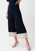 Woman wearing Joseph Ribkoff midnight blue moonstone culotte pants with color block hem