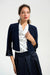 Woman wearing a dark blue open front bolero with 3/4 sleeve bell sleeves from Joseph Ribkoff