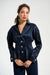 Woman wearing a dark blue pleated blouse with gold button front and long sleeves from Joseph Ribkoff