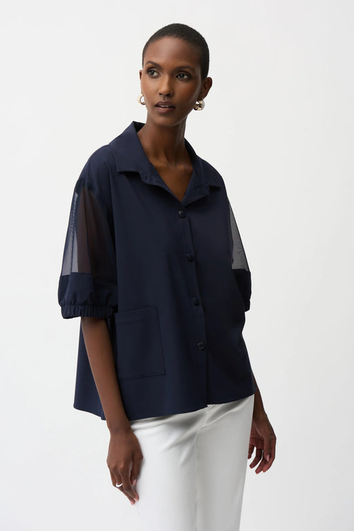 Woman wearing Joseph Ribkoff midnight blue poplin and mesh boxy blouse styled for office wear, smart casual outings, travel, and modern chic looks.
