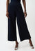 Woman wearing a dark blue cropped wide leg pants with side slit hem from Joseph Ribkoff