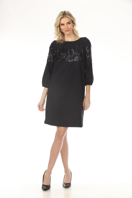 Woman wearing a dark blue sequined shift dress with side pockets and above the knee length from Joseph Ribkoff