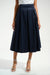 Woman wearing a dark blue pleated midi flared skirt with high waist and side pockets from Joseph Ribkoff