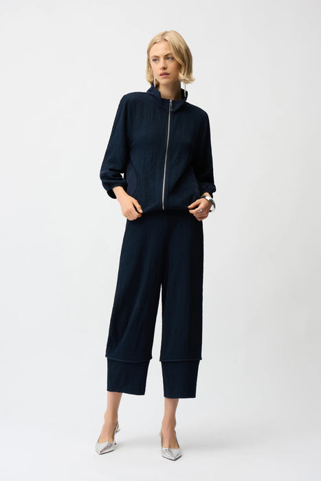 Woman wearing a navy blue textured pull on cropped pants with wide leg from Joseph Ribkoff