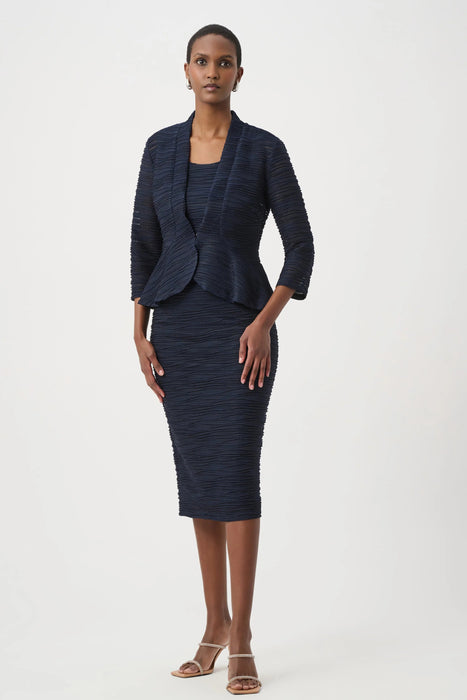 Woman wearing a dark blue textured midi pencil skirt with pull on high waist from Joseph Ribkoff