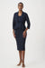 Woman wearing a dark blue textured midi pencil skirt with pull on high waist from Joseph Ribkoff