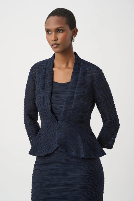 Woman wearing a dark blue textured peplum 3/4 sleeves jacket with an inner tank from Joseph Ribkoff