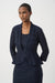 Woman wearing a dark blue textured peplum 3/4 sleeves jacket with an inner tank from Joseph Ribkoff