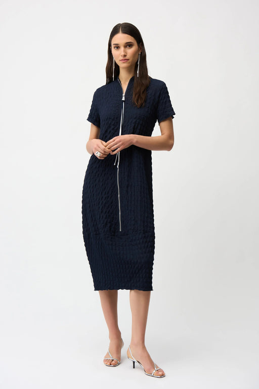Woman wearing a dark blue bubble jacquard midi dress with zipper front and short sleeves from Joseph Ribkoff