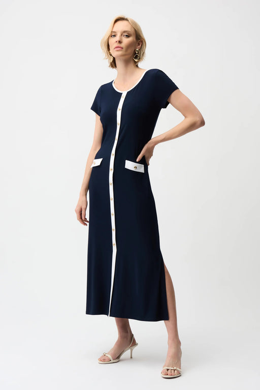 Woman wearing Joseph Ribkoff midnight blue and vanilla color block A-line midi dress with button front detail, short sleeves, and elegant contrast trim.