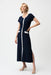 Woman wearing Joseph Ribkoff midnight blue and vanilla color block A-line midi dress with button front detail, short sleeves, and elegant contrast trim.