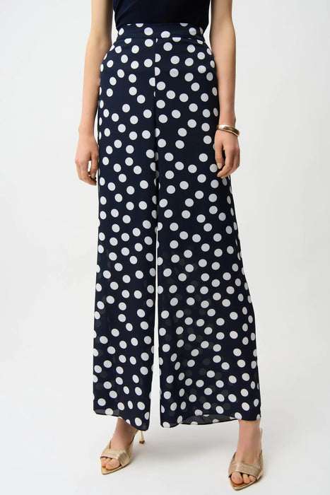 Woman wearing Joseph Ribkoff midnight blue polka dot wide leg pants