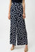 Woman wearing Joseph Ribkoff midnight blue polka dot wide leg pants