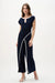 Woman wearing midnight blue culotte jumpsuit with draped bodice and contrast vanilla piping detail for an elegant evening look