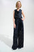 Woman wearing a dark blue wide leg pants with white polka dots and waist sash from Joseph Ribkoff