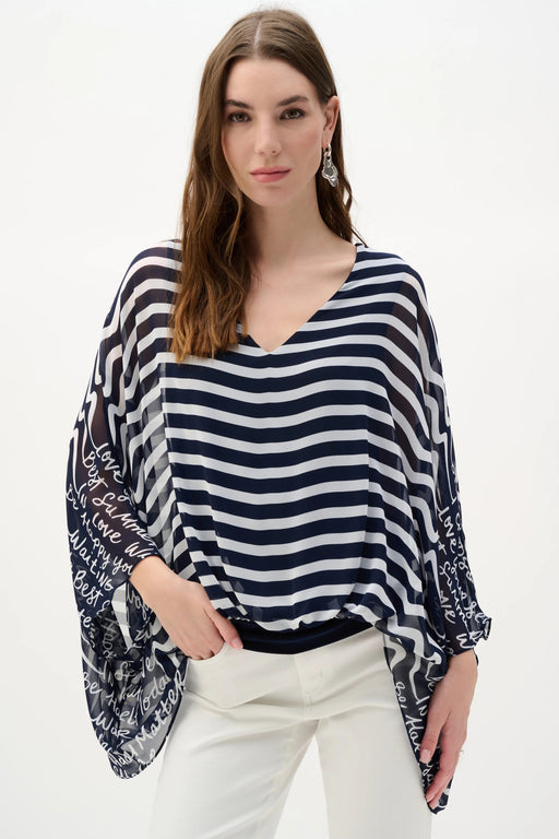 Woman wearing Joseph Ribkoff midnight blue and vanilla stripe print poncho top styled for resort wear, vacation outfits, summer outings, and casual chic looks.