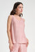 Woman wearing a pink pleated sleeveless top with scoop neck from Joseph Ribkoff