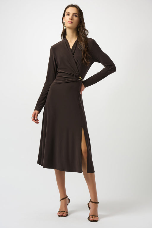 Woman wearing a brown silky knit fit and flare dress chain detail on the waist and wrap v-neck
