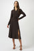 Woman wearing a brown silky knit fit and flare dress chain detail on the waist and wrap v-neck