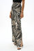 Woman wearing Joseph Ribkoff abstract print wide leg pants styled for resort wear, evening outfits, travel looks, and modern statement fashion.