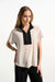 Woman wearing a beige and black two-tone color block short sleeve top with zip up front from Joseph Ribkoff