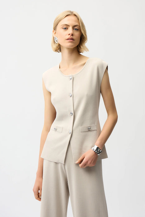 Woman wearing a beige button front knitted vest from Joseph Ribkoff