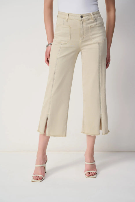 Woman wearing beige cropped jeans with rhinestone embellishments and frayed hem from Joseph Ribkoff