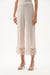 Woman wearing Joseph Ribkoff moonstone guipure lace culotte pants
