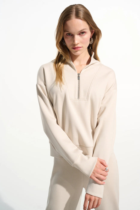 Woman wearing Joseph Ribkoff high collar front zip sweatshirt in scuba jersey styled for casual chic outfits, travel wear, and modern layering looks.