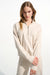 Woman wearing Joseph Ribkoff high collar front zip sweatshirt in scuba jersey styled for casual chic outfits, travel wear, and modern layering looks.