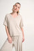 Woman wearing Joseph Ribkoff jersey dolman sleeve boxy top styled for casual chic, office wear, travel, and modern everyday fashion looks.