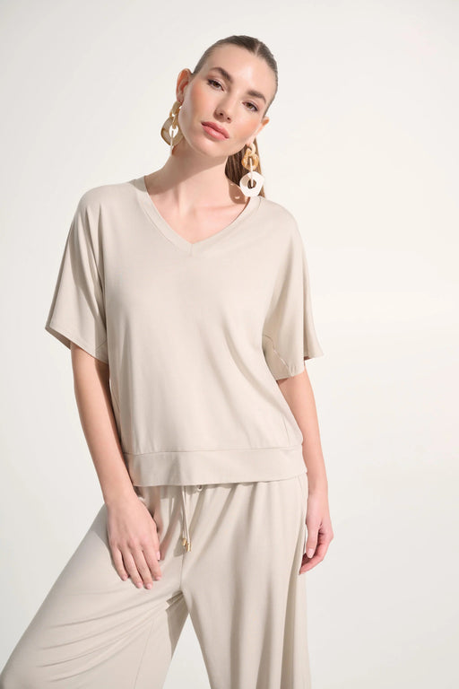 Woman wearing Joseph Ribkoff jersey dolman sleeve boxy top styled for casual chic, office wear, travel, and modern everyday fashion looks.