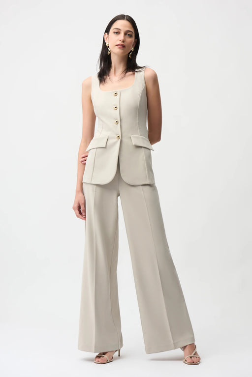 Woman wearing Joseph Ribkoff moonstone lux twill wide-leg pantsuit-style jumpsuit with square neckline, gold buttons, and tailored fit for an elegant modern look.