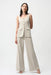 Woman wearing Joseph Ribkoff moonstone lux twill wide-leg pantsuit-style jumpsuit with square neckline, gold buttons, and tailored fit for an elegant modern look.