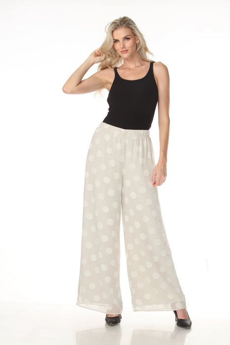 Woman styling Joseph Ribkoff polka dot wide-leg trousers for office wear
