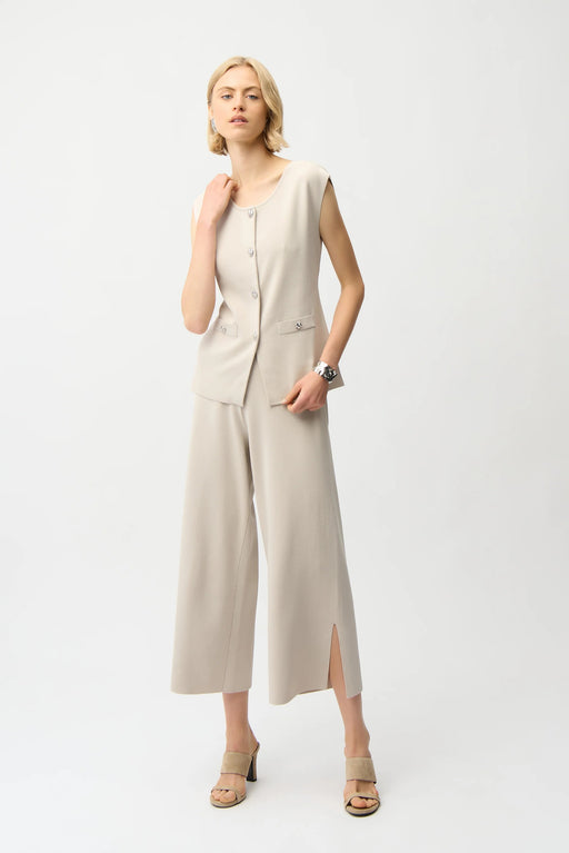 Woman wearing a beige cropped wide leg pants with side slit hem from Joseph Ribkoff